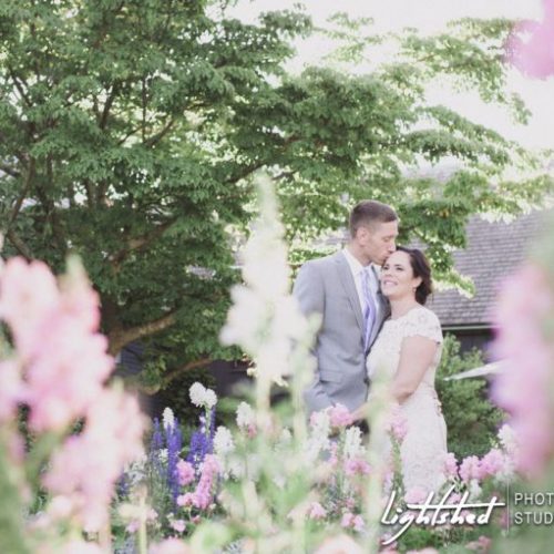 A couple who got married at The House of the Seven Gables surrounded by flowers