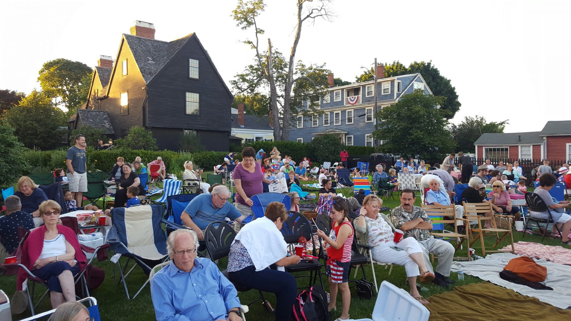 The seaside lawn at The House of the Seven Gables is full of people ready to celebrate the Fourth of July