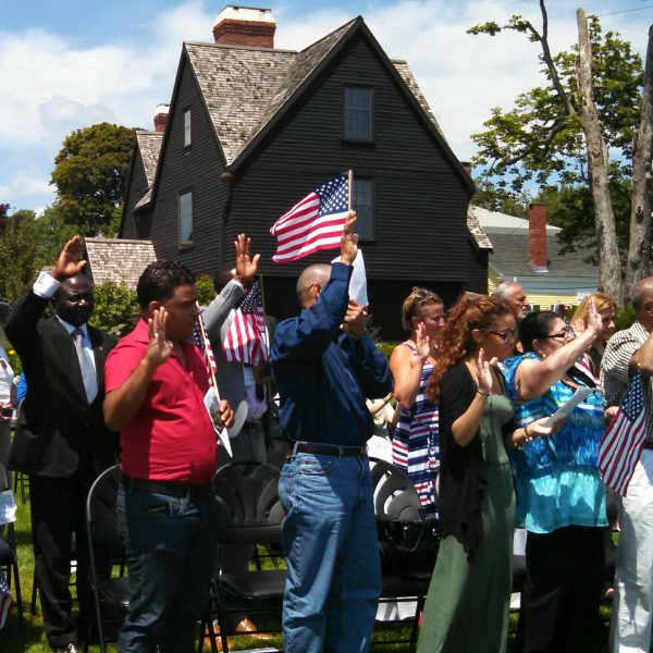 Picture of new American citizens being sworn in at The House of the Seven Gables