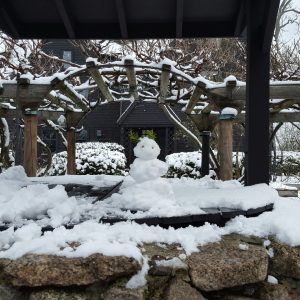 A snowman on the well at The House of the Seven Gables