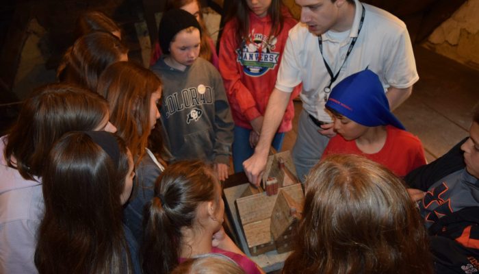 A guide with school-age children at The House of the Seven Gables