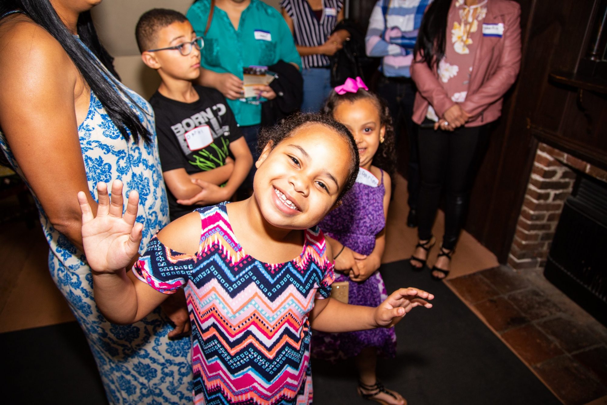 A little girl with a big smile poses inside the Gables