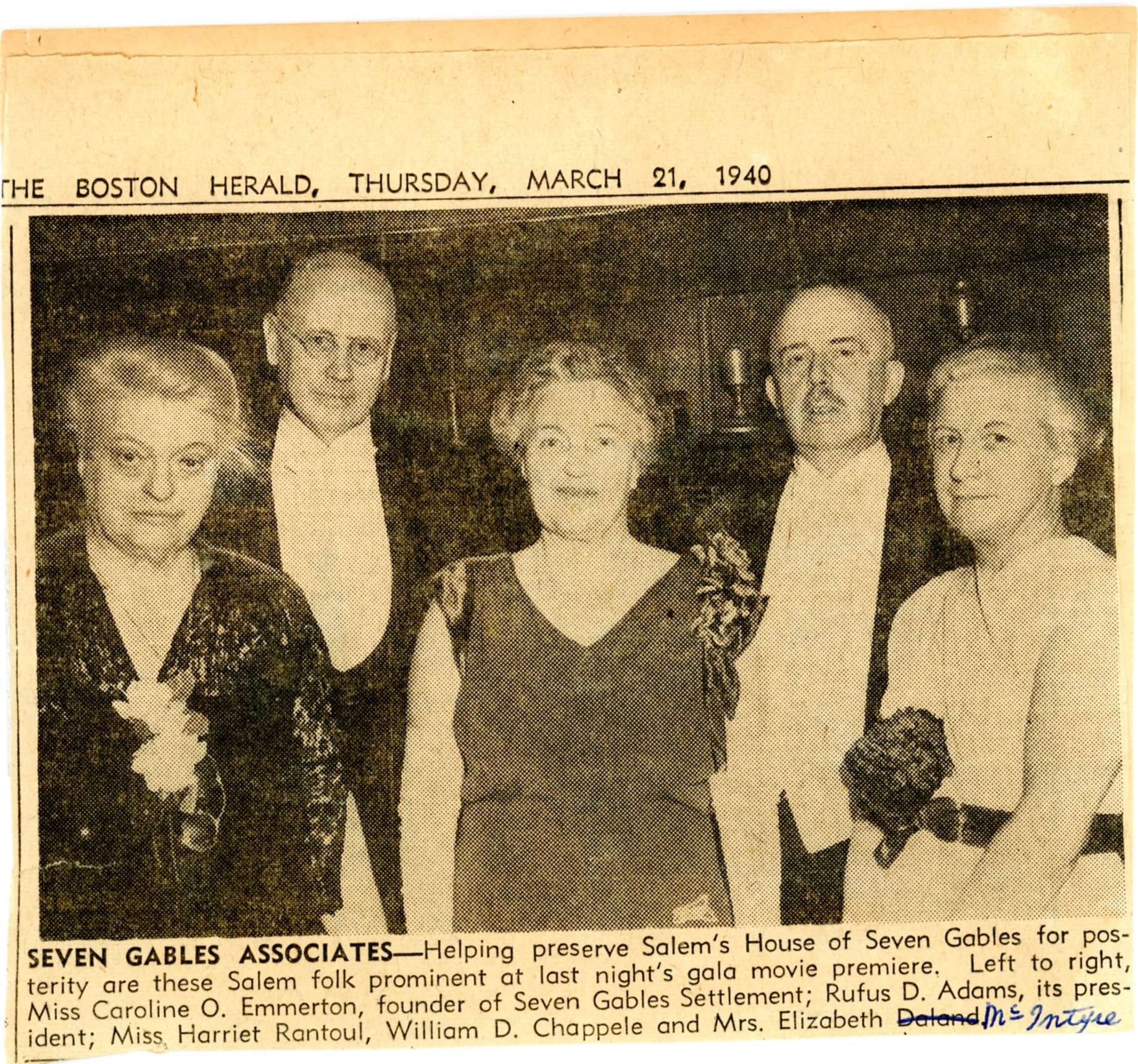Newspaper photograph of three women and two men