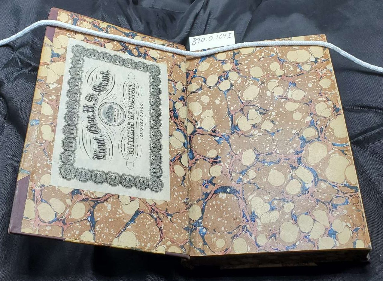 A marbled book cover with leather spine and covers.|A brown leather book spine with a red field and a green field. Red field contains text: Hawthorne's Works. Green field contains text: Snow-Image.|The marbled endpages of a book with the bookplate of Ulysses S. Grant. pasted on it.