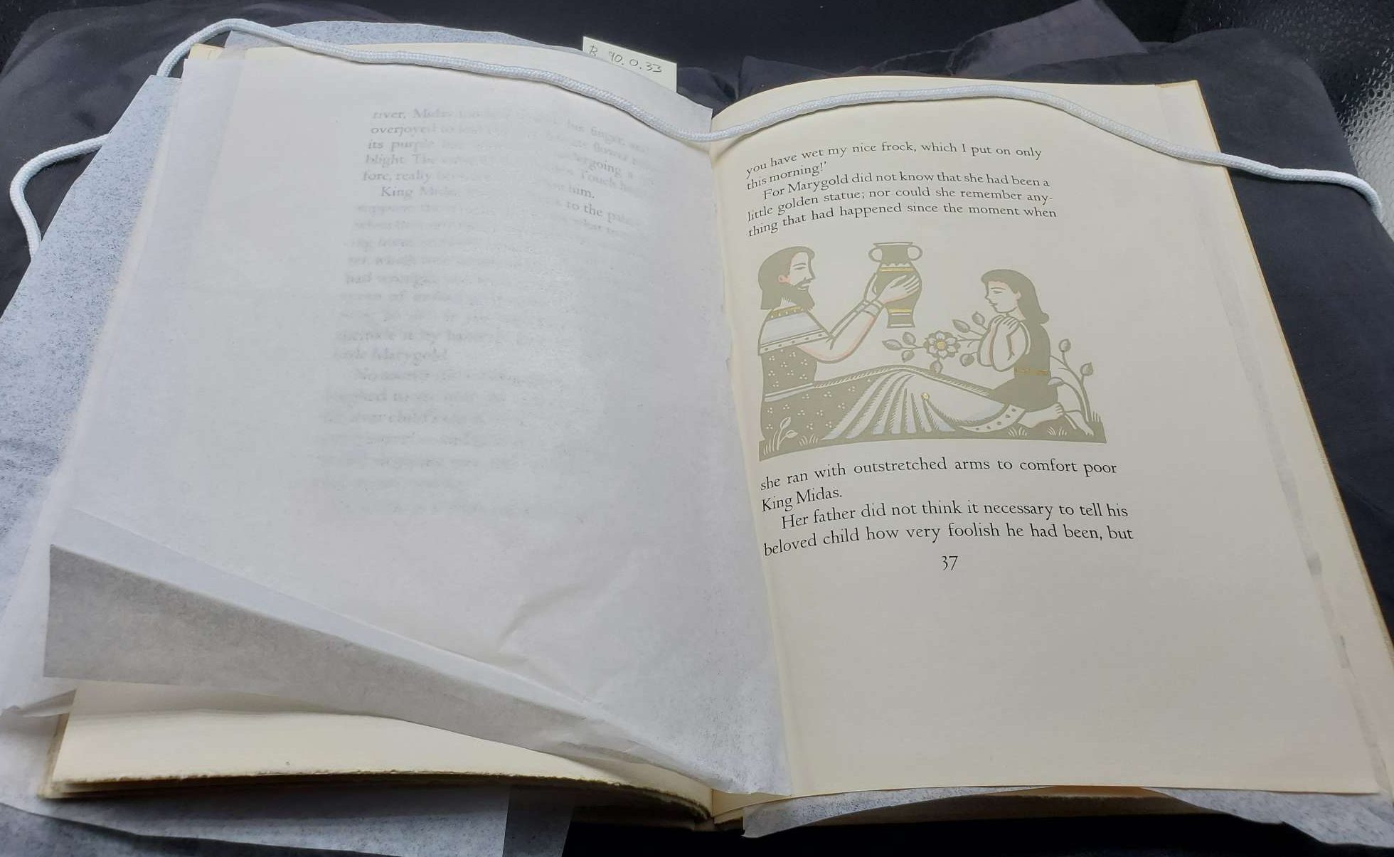 A beige book cover with a paper bird medallion.|A title page with an illustration of a king and child