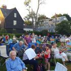 The seaside lawn at The House of the Seven Gables is full of people ready to celebrate the Fourth of July