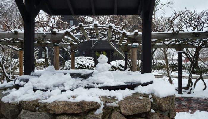 A snowman on the well at The House of the Seven Gables