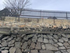 Photo of a portion of the sea wall at The Gables that needs to be repointed (repaired) after damage in January 2022.