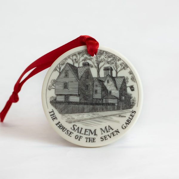 The front view of the House of the Seven Gables scrimshaw ornament that features an etched image of the Turner Street view of the House of the Seven Gables in detail.