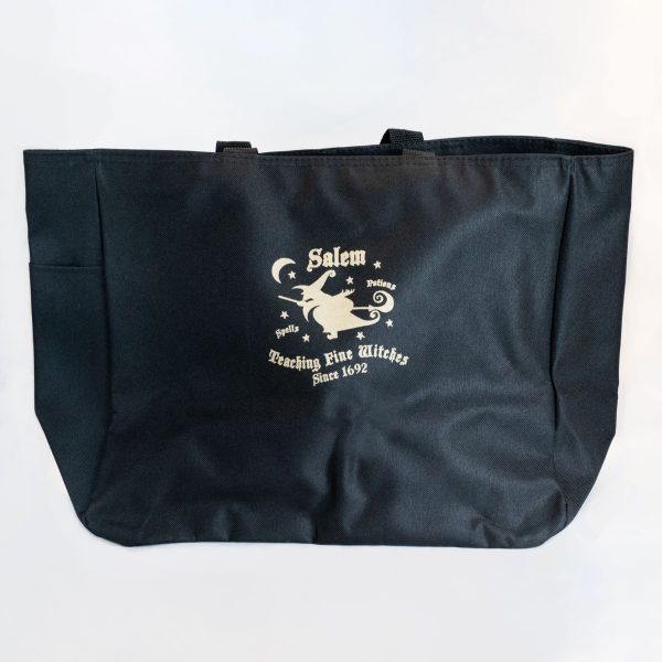 The front side of the Teaching Fine Witches Tote Bag that features an image of a witch flying through the night sky on a broom.