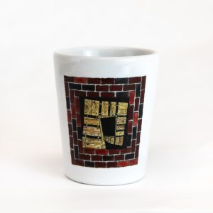 The front of the I Climbed the Secret Staircase! Shot Glass that features an illustration of the secret staircase.