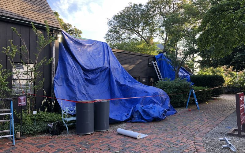 Tarps cover the Tea House and Barn as their roofs are in the process of being replaced.