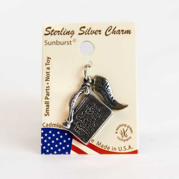 The sterling silver House of the Seven Gables Book Charm that features a quill pen and flag reading, "The House of the Seven Gables."