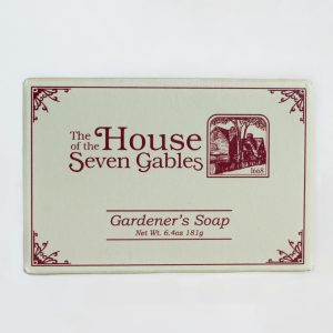 The front packaging of the House of the Seven Gables' Gardner's Soap. It comes in a small box with House of the Seven Gables branding.