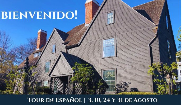 The exterior of The House of the Seven Gables on a clear spring day with text at the top reading "bienvenido" and text along the bottom detailing dates for Spanish language tours.