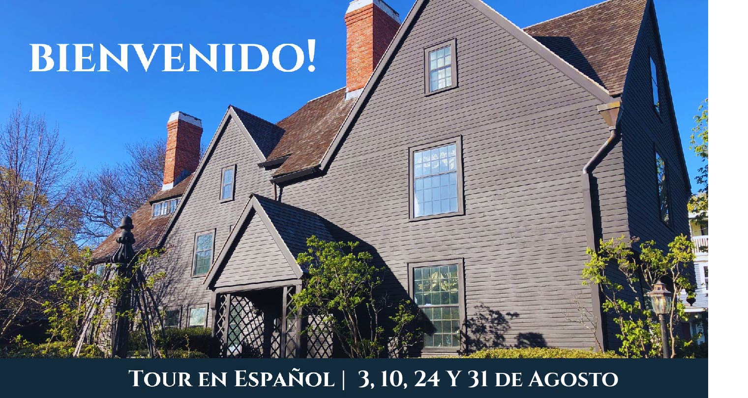 The exterior of The House of the Seven Gables on a clear spring day with text at the top reading "bienvenido" and text along the bottom detailing dates for Spanish language tours.